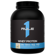 Black protein powder container with a blue label front view showing nutritional claims and flavor